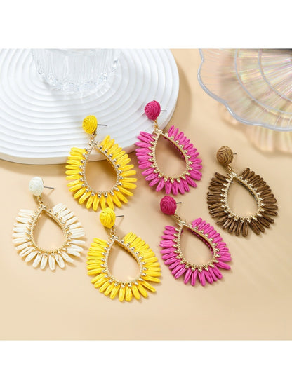 Close-up of Earedge minimalist oval raffia drop earrings on white background