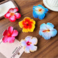 Beau lifelike hibiscus shaped claw clip in soft pink on white background