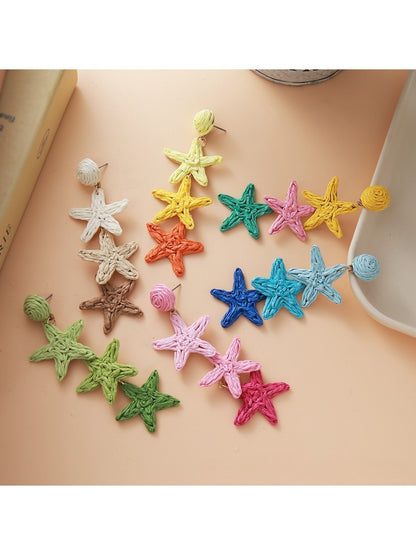 Close-up of Earedge cute star pendant earrings on white background