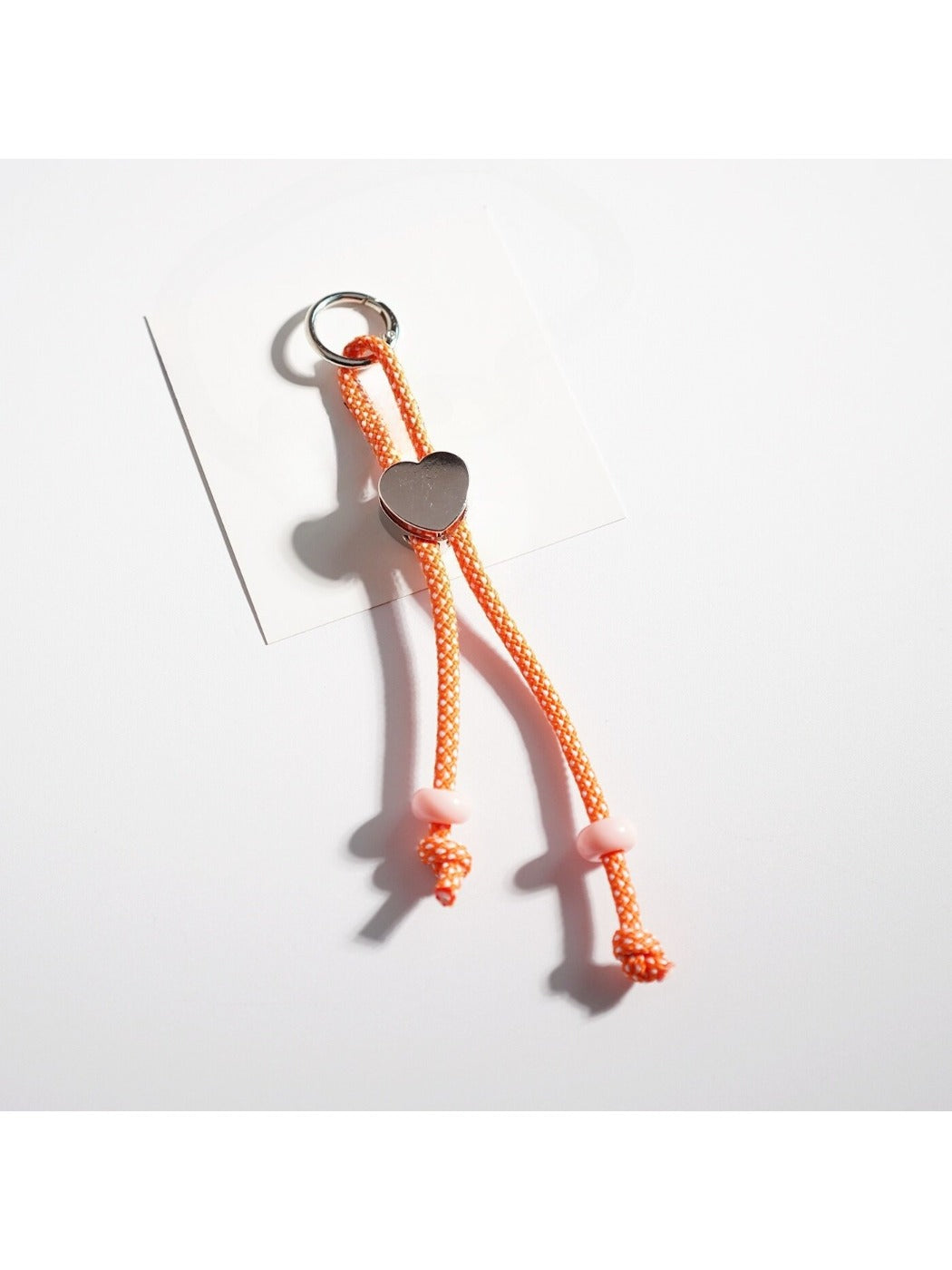 Detailed view of colorful rope heart keychain showing texture and colors