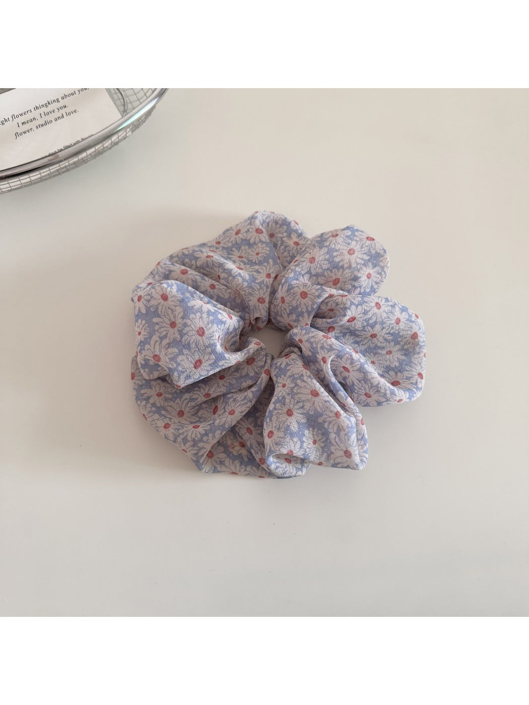 Model wearing Gifty daisy print scrunchie in hair with loose waves
