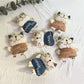 Back view of the cartoon cat keychain displaying a smooth surface