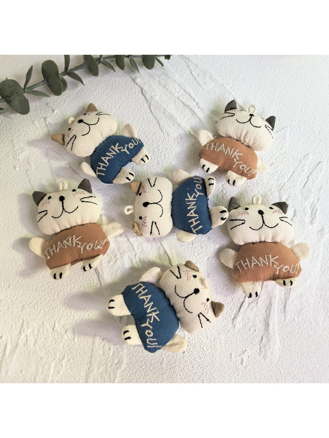 Back view of the cartoon cat keychain displaying a smooth surface