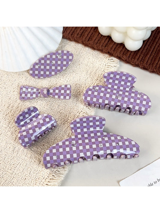 Purple plaid hair claw clip with curved teeth on white background