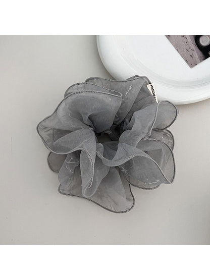 Multiple Gifty ruffled scrunchies in different colors arranged together