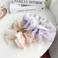 Side view of Beau floral print hair claw clip with curved grip teeth