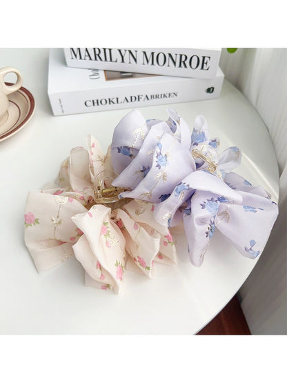 Side view of Beau floral print hair claw clip with curved grip teeth