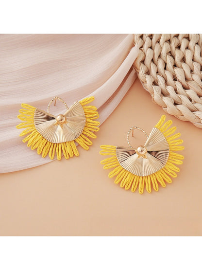 Earedge raffia woven fan shape earrings displayed flat on textured fabric