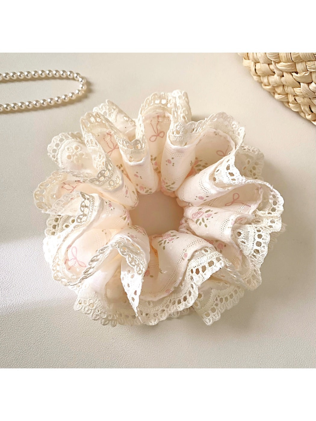 Close-up of Gifty Sweet Bow Print Ruffled Scrunchie with pink and white bow pattern
