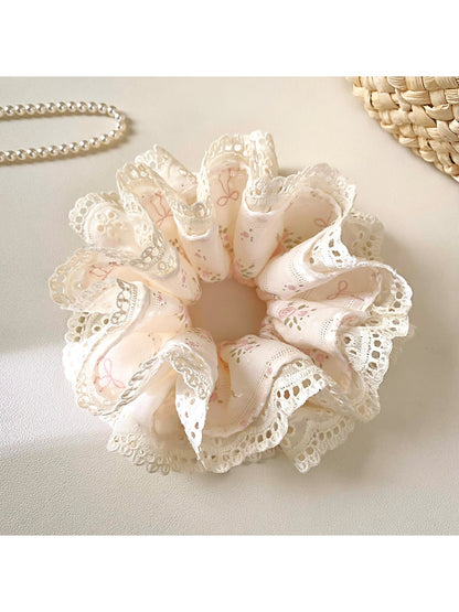 Close-up of Gifty Sweet Bow Print Ruffled Scrunchie with pink and white bow pattern