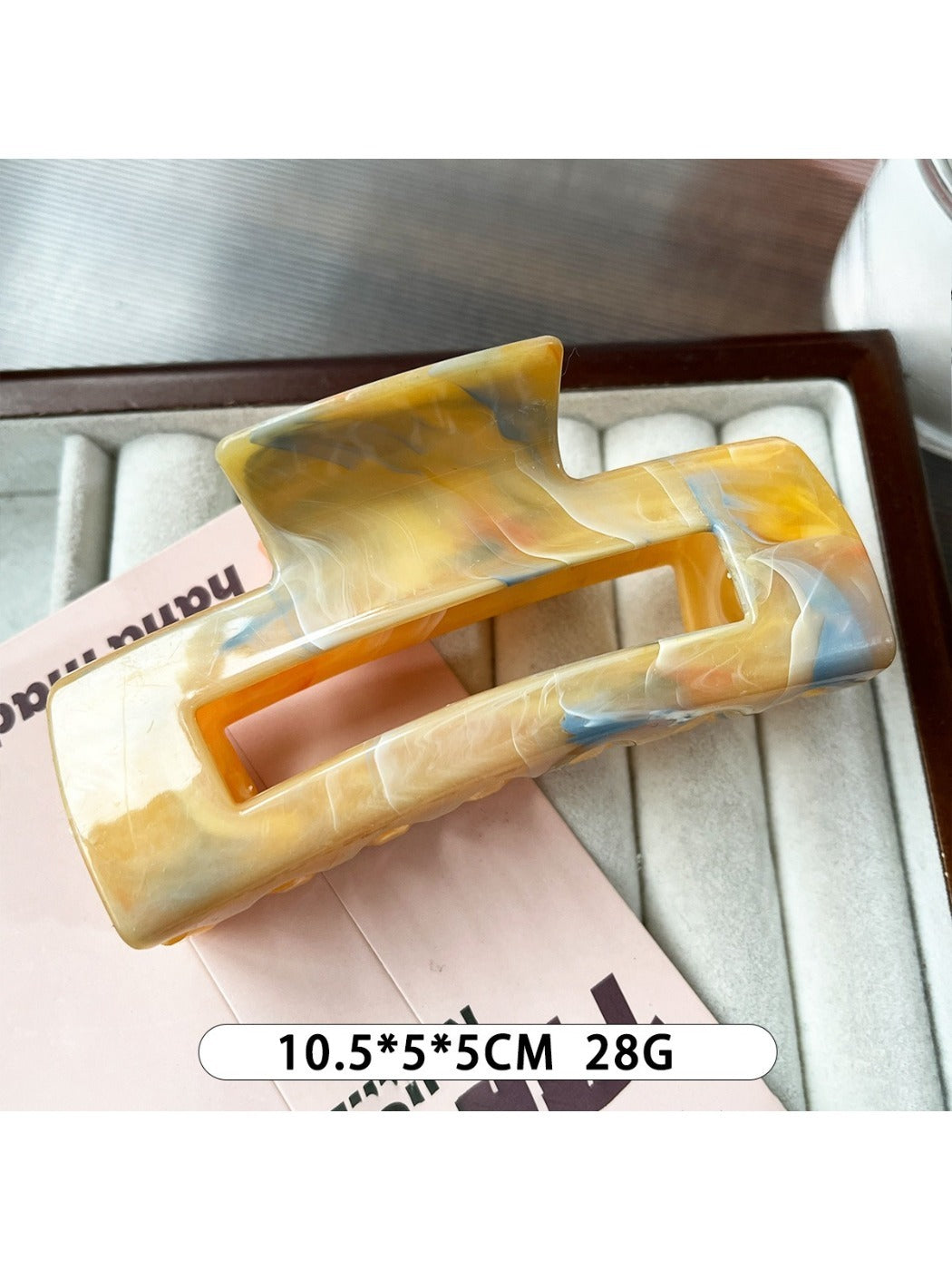 Beau marble pattern square claw clip open to display inner teeth and grip