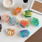 Side view of Beau colorful fish claw clip highlighting the curved design
