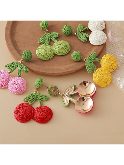 Pair of cherry shaped earrings made from natural raffia fibers