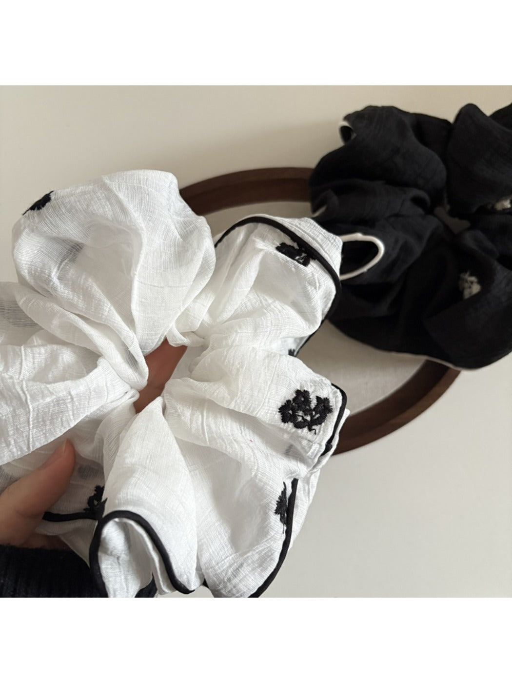 Gifty small delicate mesh scrunchie stretched to show elastic band inside