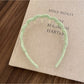 Gifty solid color wavy headband folded to show flexibility and material