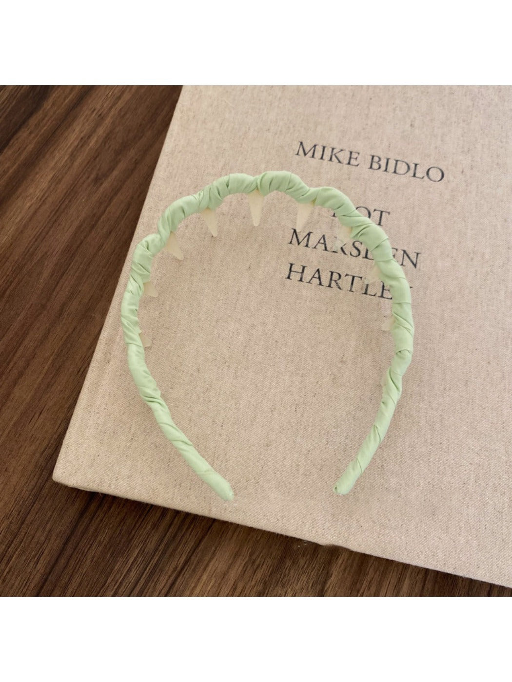 Gifty solid color wavy headband folded to show flexibility and material