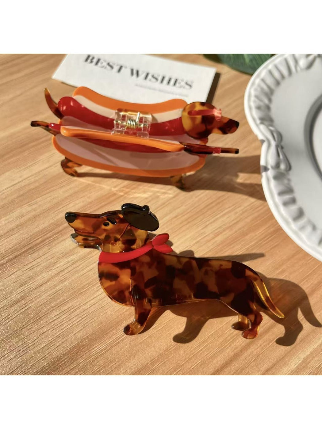 Close-up of Beau dachshund claw clip showing detailed cartoon dog face and ears