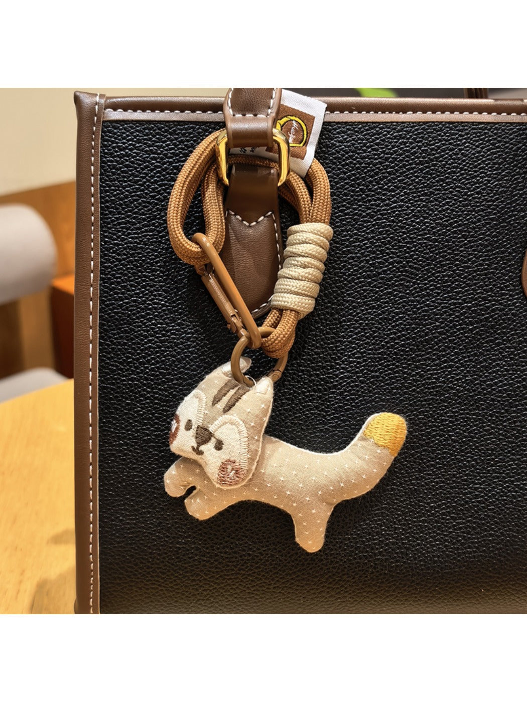 Keypus squirrel charm keychain held in hand to show size and detail