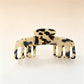 Beau soft acetate claw clip held in hand to show size and grip
