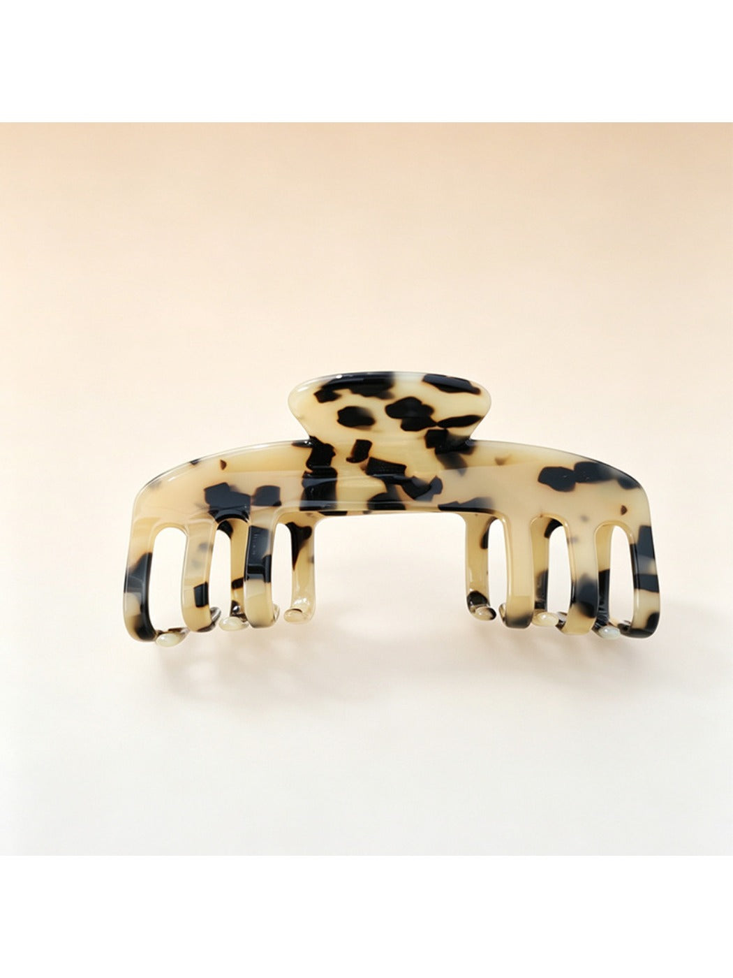 Beau soft acetate claw clip held in hand to show size and grip