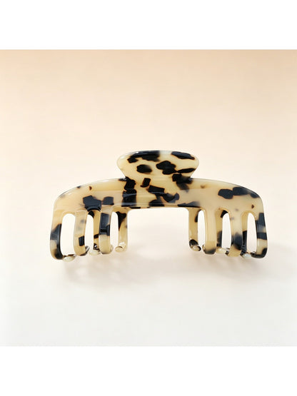 Beau soft acetate claw clip held in hand to show size and grip