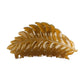 Beau hair clip on a marble countertop with soft lighting