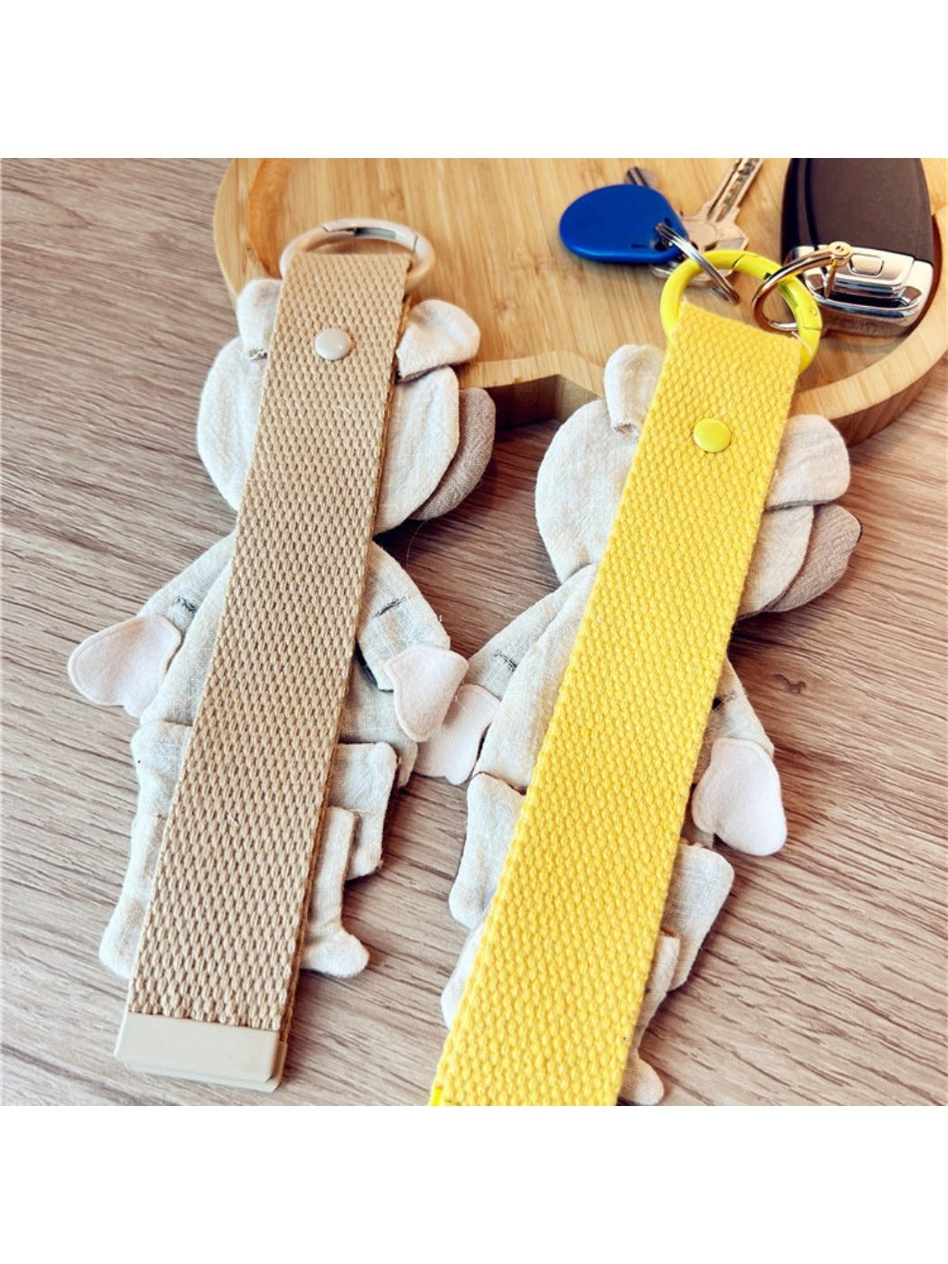 Fabric patchwork bear keychain attached to a metal keyring on a white background