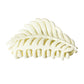 Beau leaf hair clip with light reflecting off its surface
