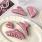 Close-up of pink plaid pattern on Beau crescent claw clip