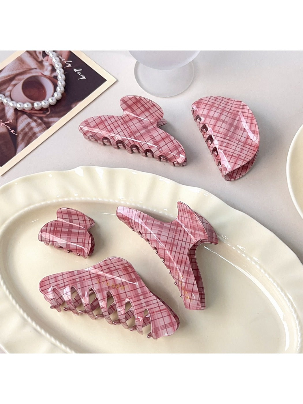 Close-up of pink plaid pattern on Beau crescent claw clip