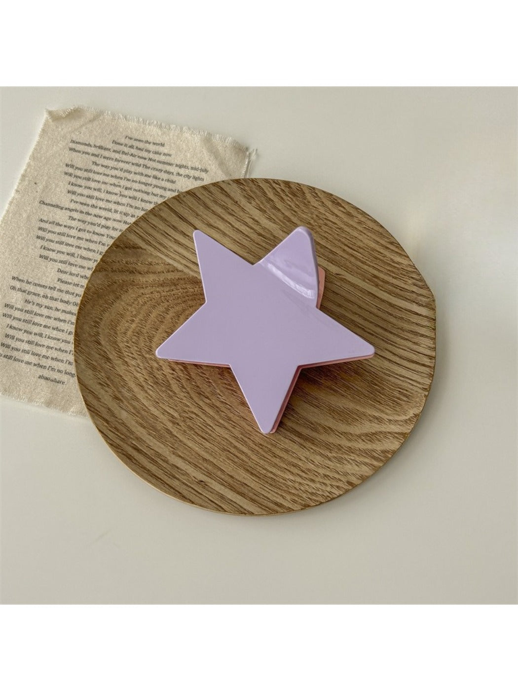 Beau star shaped claw clip displayed with hair strands to show use