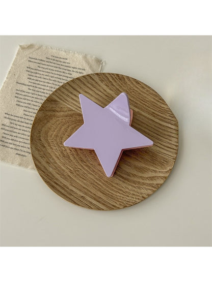 Beau star shaped claw clip displayed with hair strands to show use