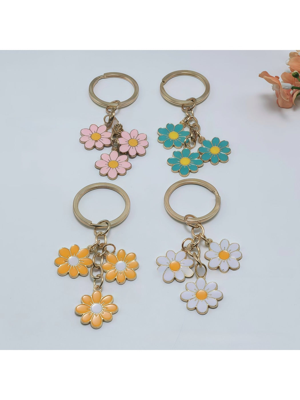 Sweet peach blossom shaped keychain with soft pink petals and gold keyring