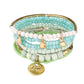 Model's hand adorned with Lovra stackable beaded bracelets holding a coffee cup