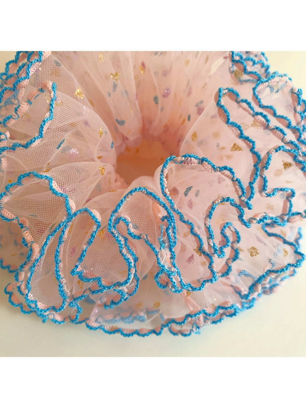 Four-layer ruffled scrunchie displayed flat showing its full circular shape