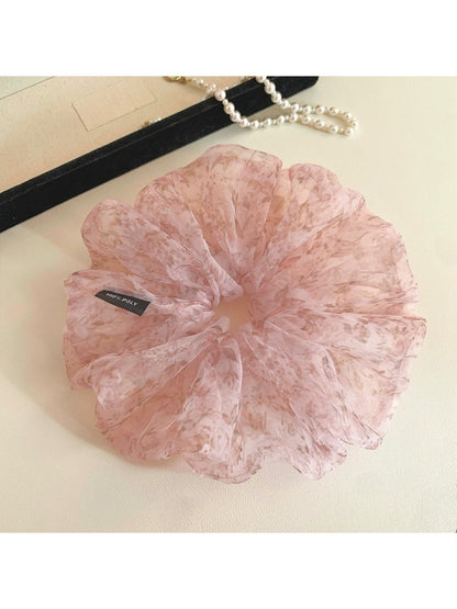 Large pink tulle scrunchie with tiny floral pattern on a white background