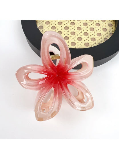Beau classic flower hair claw clip held in hand showing size and detail