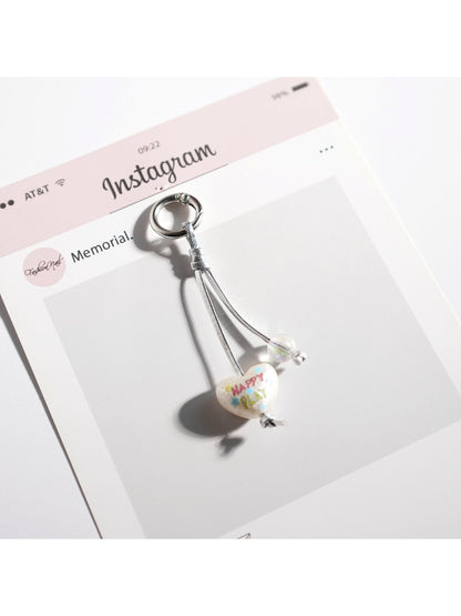 Multiple Keypus keychains in white style arranged in a row