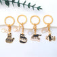 Cartoon cat piano keychain with black and white piano keys on a white background