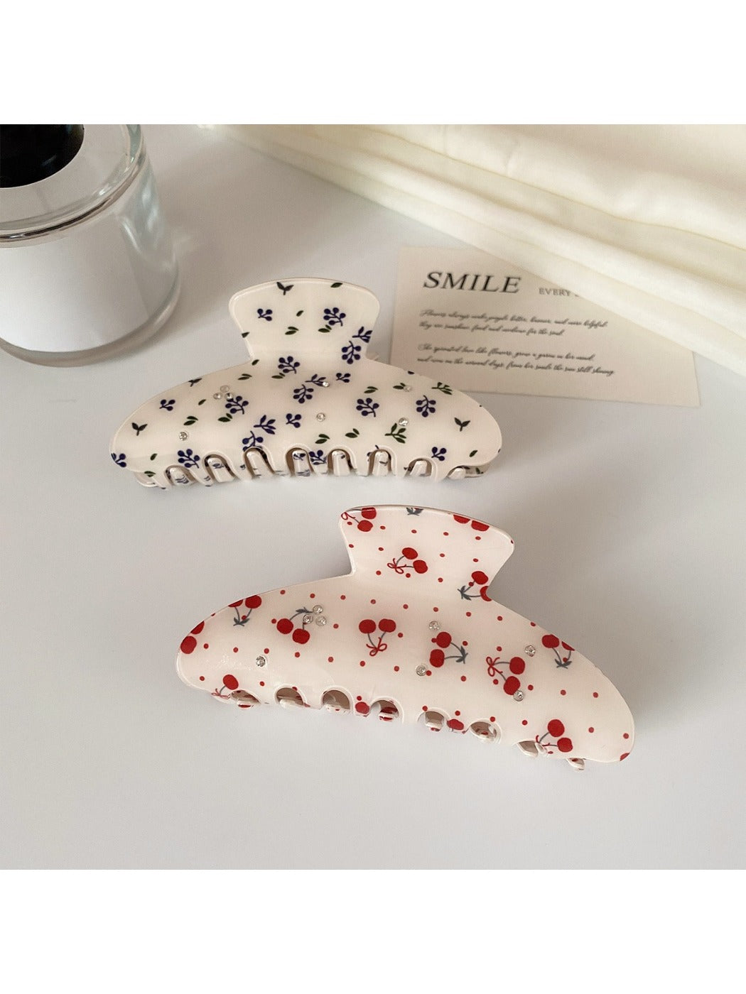 Beau hair claw clip held in hand displaying size and printed pattern details