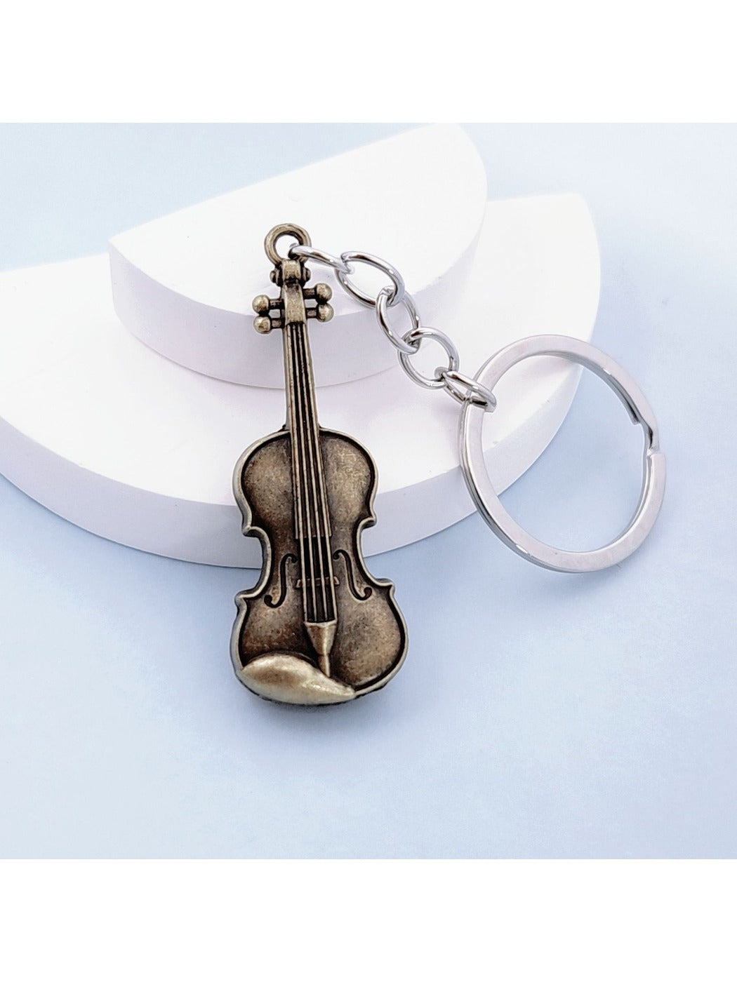 Vintage alloy guitar keychain displayed on a white background with clear lighting