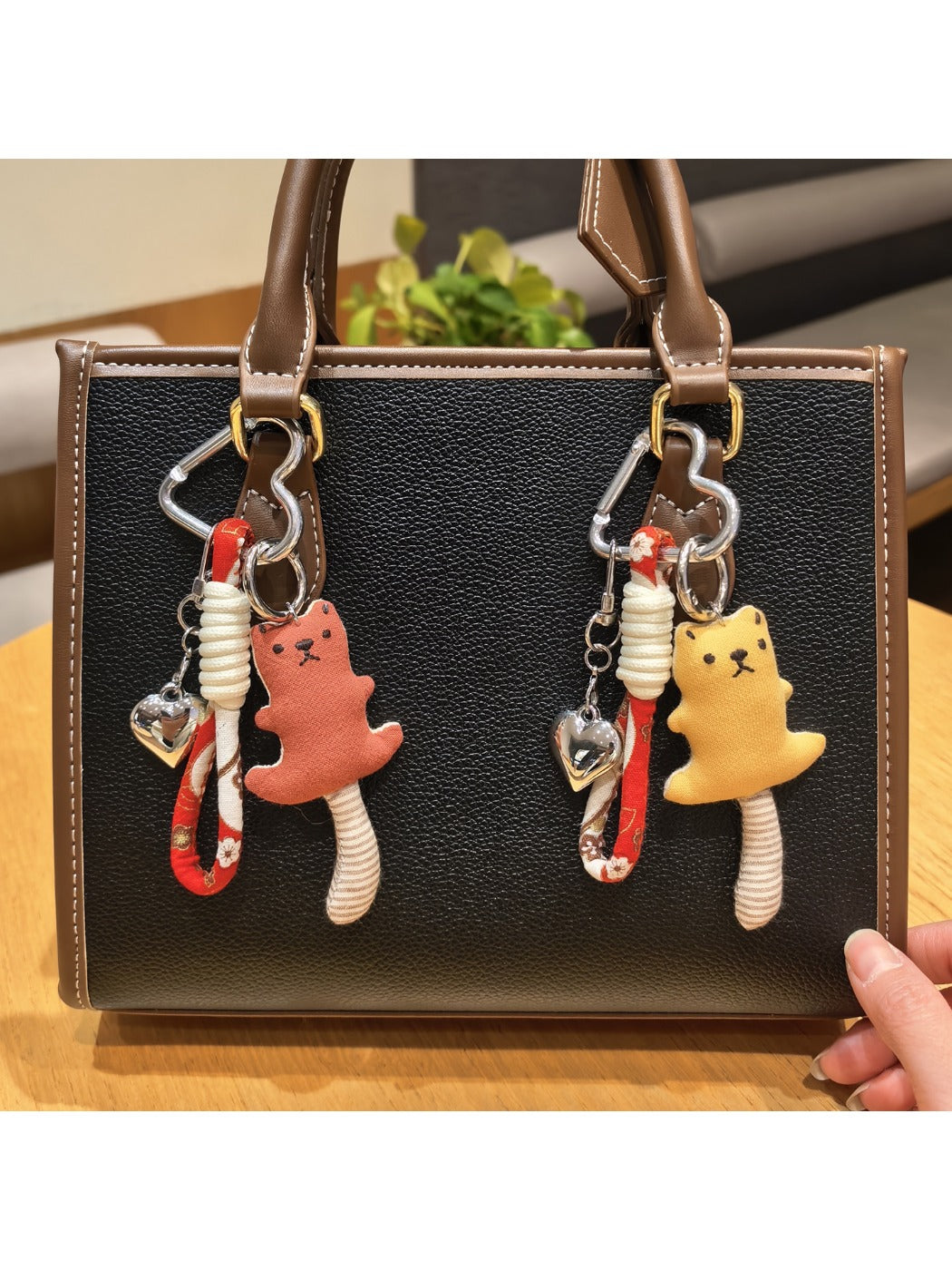 Cute long-tailed bear keychain with soft plush fur and embroidered facial features