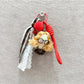 Fabric curly hair doll keychain held in hand showing size and craftsmanship