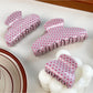 Close-up of Beau pink polka dot hair claw clip showing curved teeth