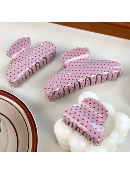 Close-up of Beau pink polka dot hair claw clip showing curved teeth