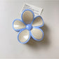 Beau flower shaped claw clip photographed from above showing full flower shape