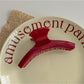 Beau red fashion hair clip angled to show thickness and glossy texture