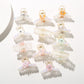 Bright multi color hair clip with curved design on white background