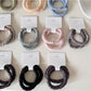 Model wearing Gifty minimalist satin hair tie holding hair in a ponytail