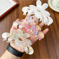 Close-up of Beau flower shaped claw clip showing petal details in pink